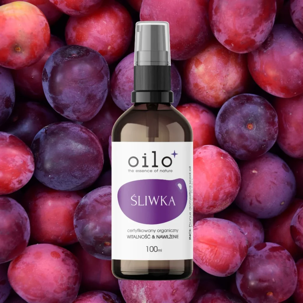 Olej śliwkowy Oilo 100 ml wśród dojrzałych śliwek