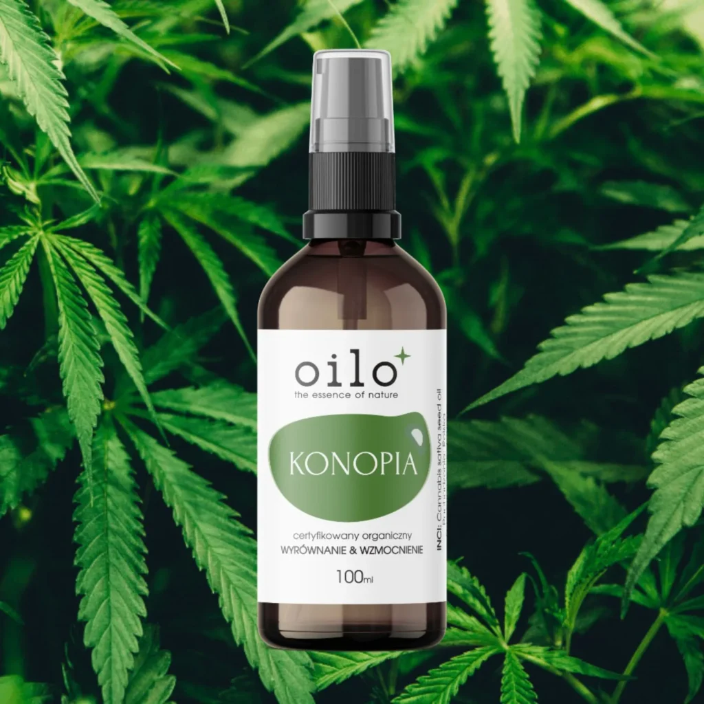 Olej konopny Oilo 100 ml wśród liści konopi